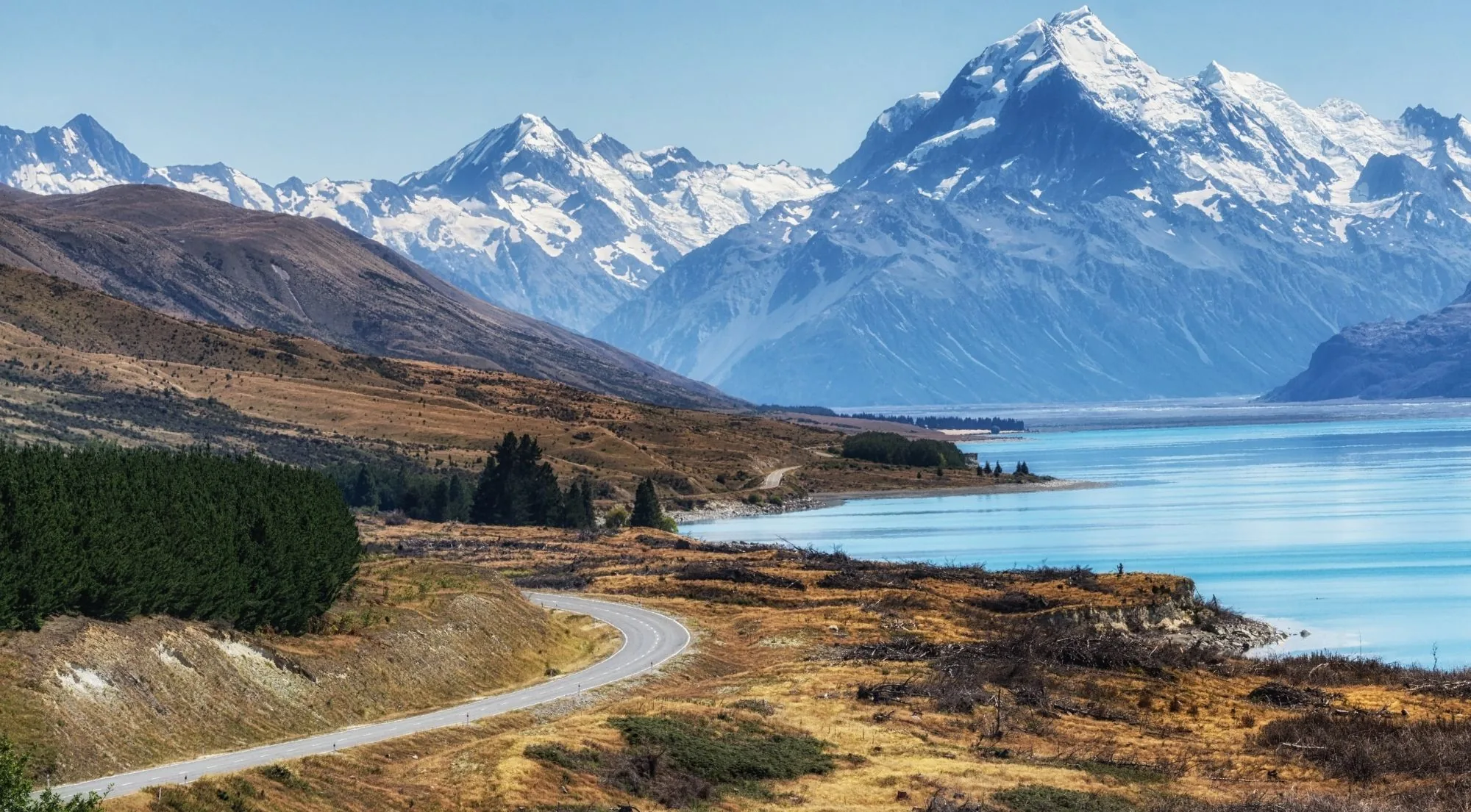 Mount Cook Road winding beside Lake Pukaki toward the Southern Alps