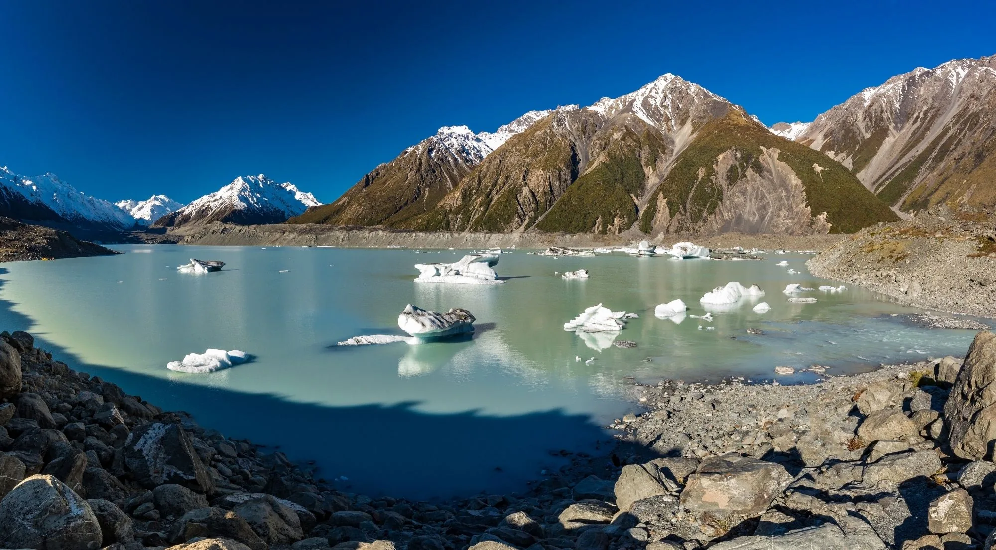 Tasman Lake scattered with icebergs beneath the peaks of the Tasman Valley