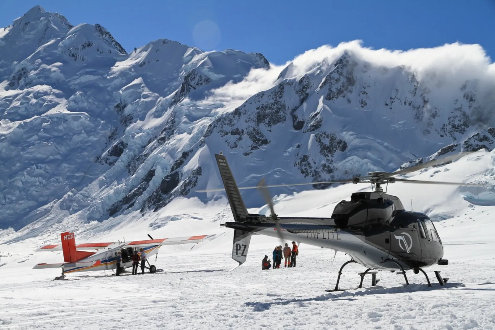 Helicopter and ski plane side by side on the Tasman Glacier below icefalls