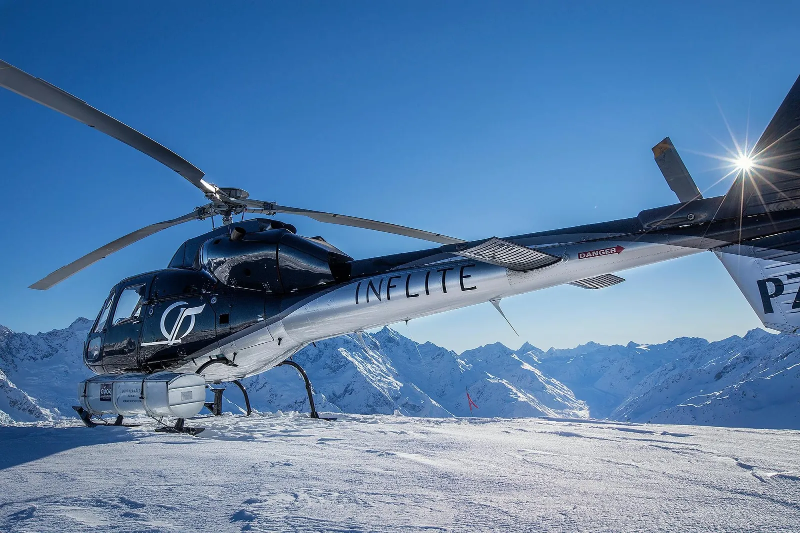 INFLITE helicopter parked on a snowfield high in the Southern Alps