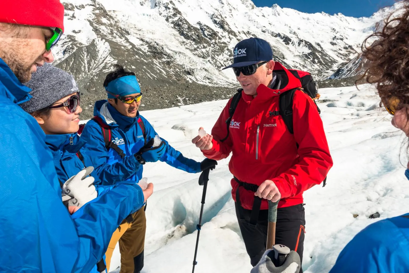 Mt Cook Glacier Guiding guide talking with hikers on the ice