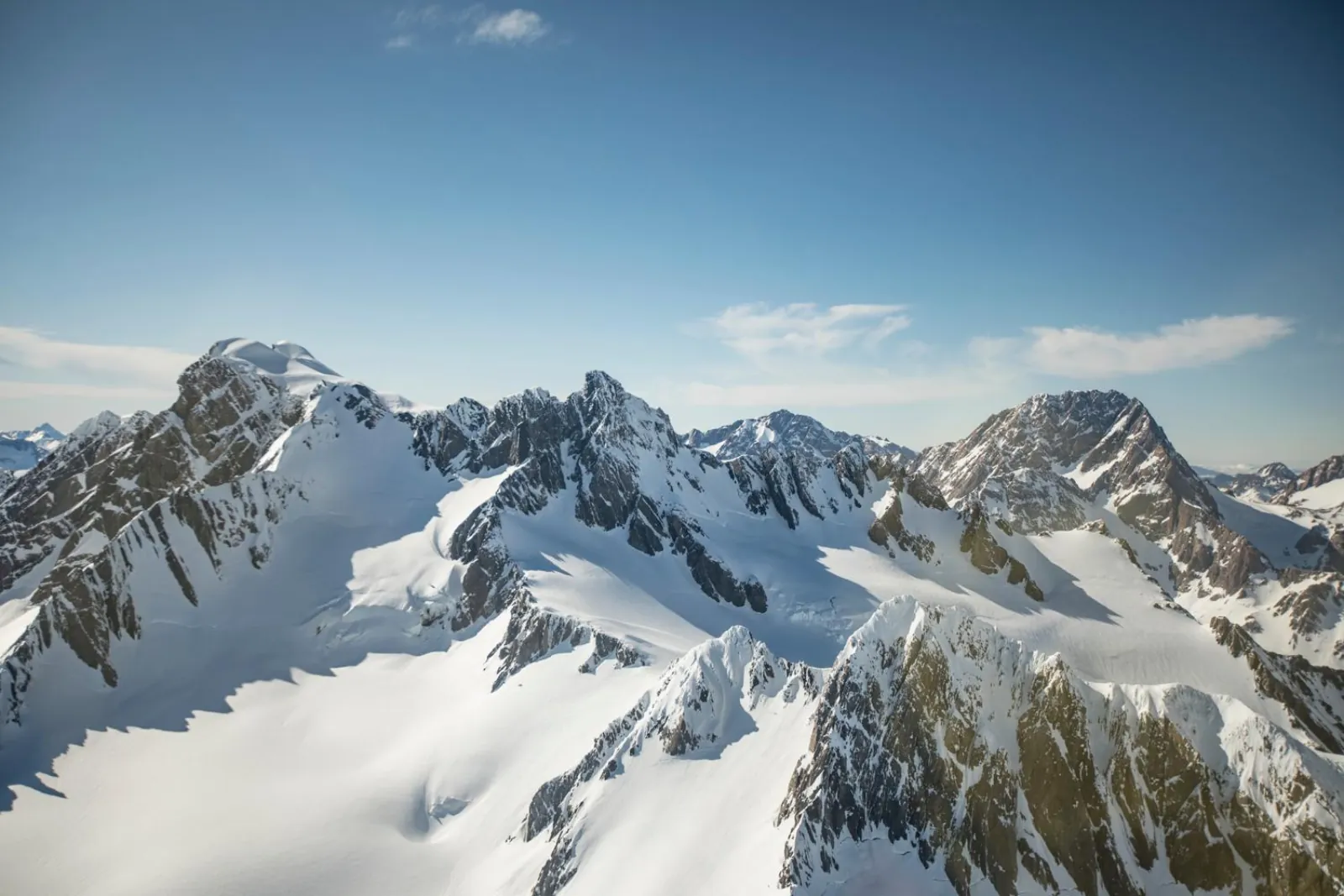 Rugged snow-covered peaks and glaciers of the national park from the air