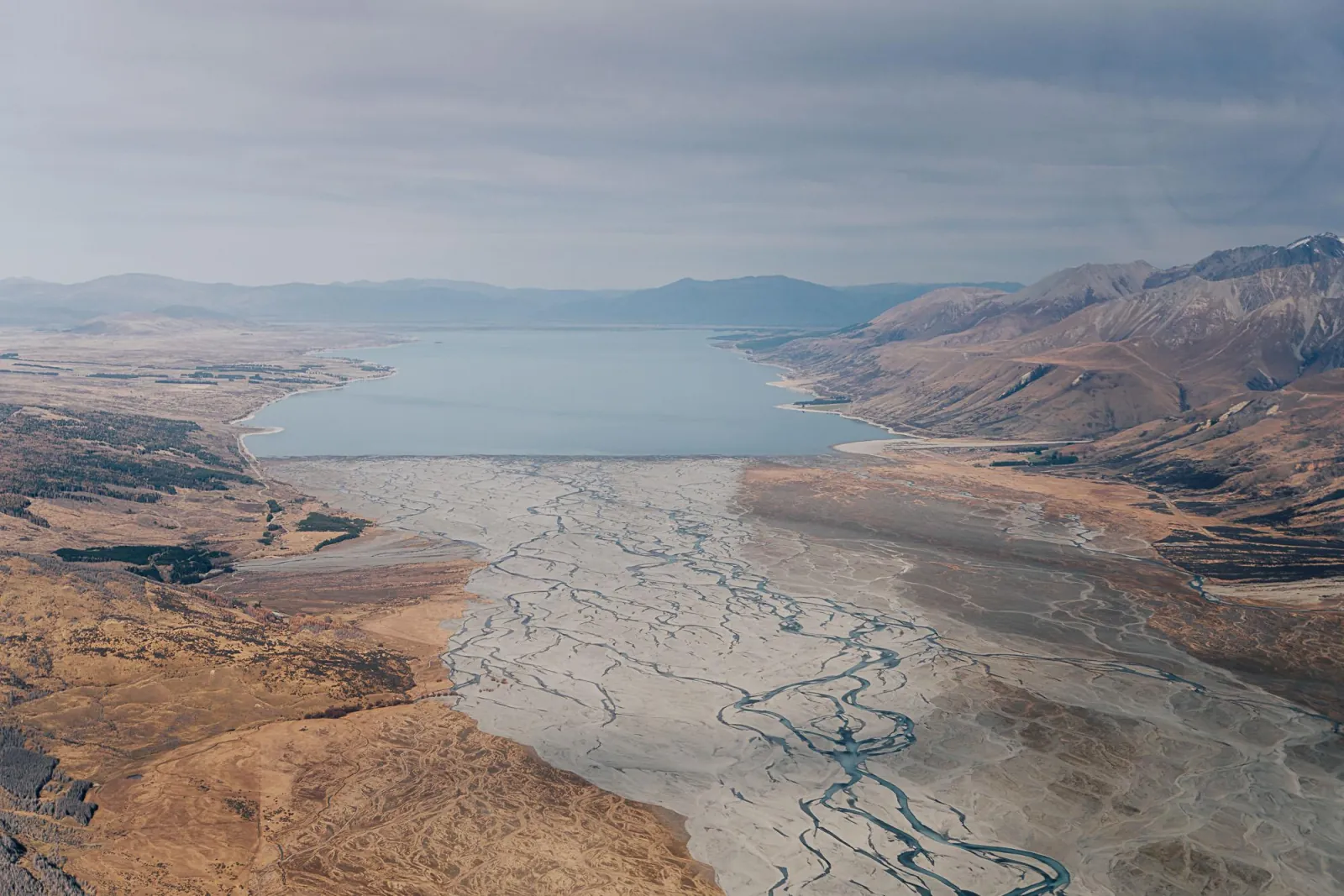 Aerial view of a glacial lake and its braided river delta in the Mackenzie high country