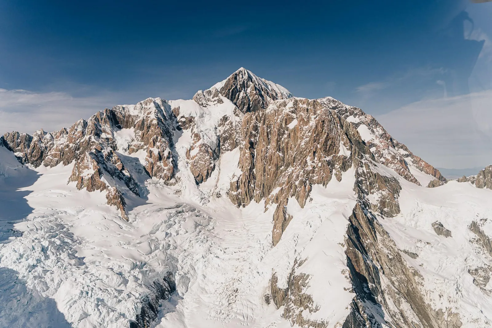 Snow-covered rock peak in the Southern Alps seen from the helicopter